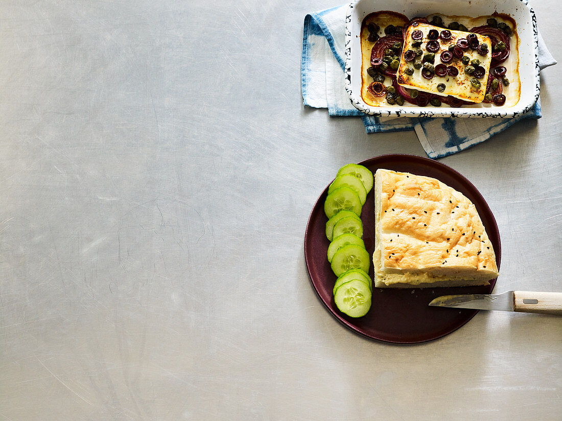 Baked feta cheese with olives and capers in unleavened bread