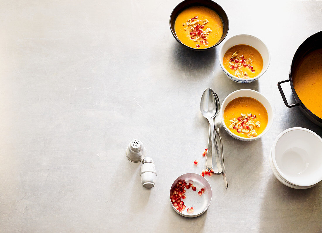 Pepper and sweet potato soup with walnuts and pomegranate seeds
