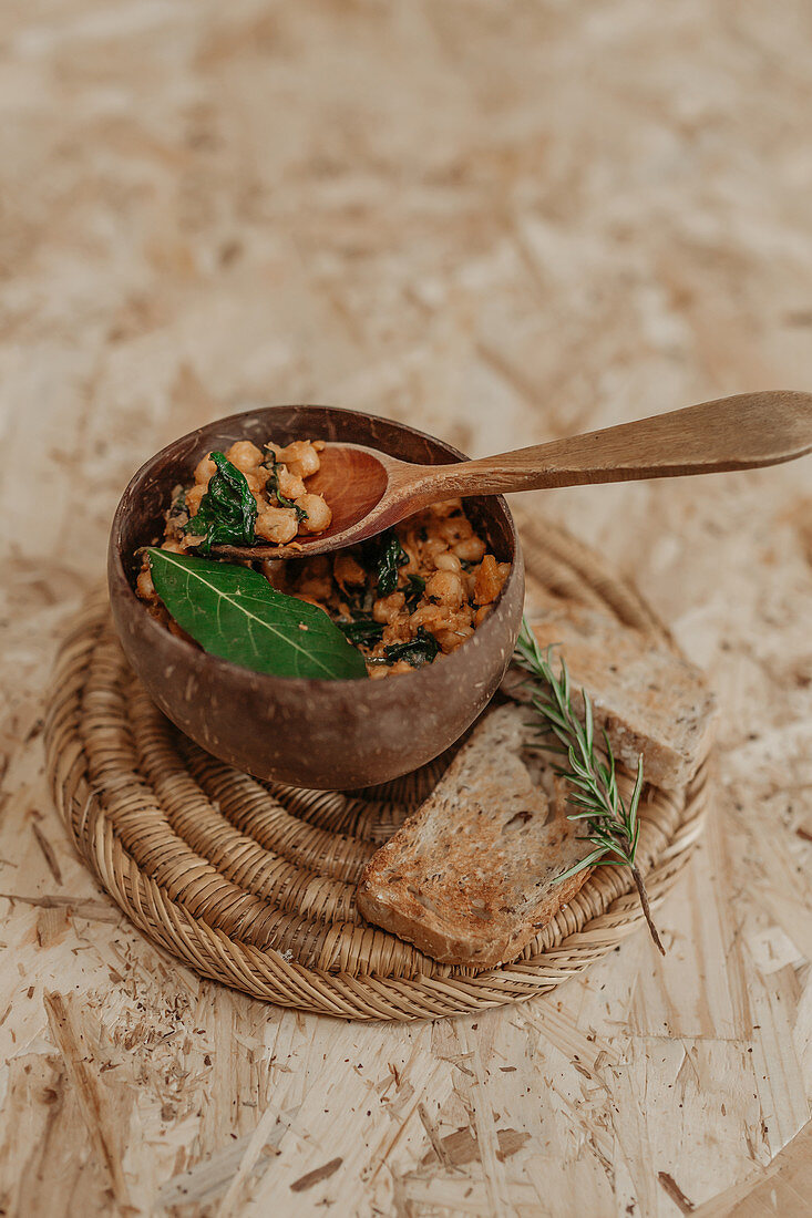 Chickpeas in bowl and slices of bread