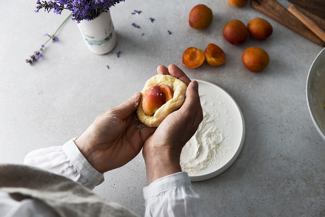 Apricot dumplings being made: dumplings being filled with apricots