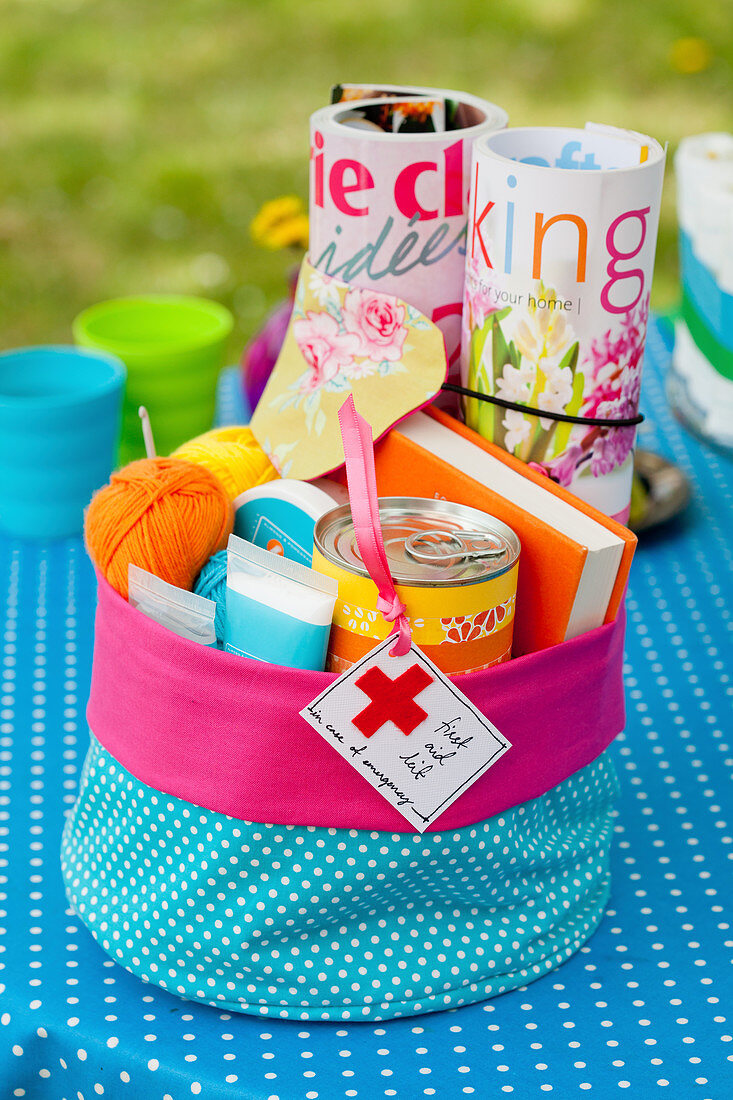 Storage basket made of polka-dotted fabric with magazines and presents