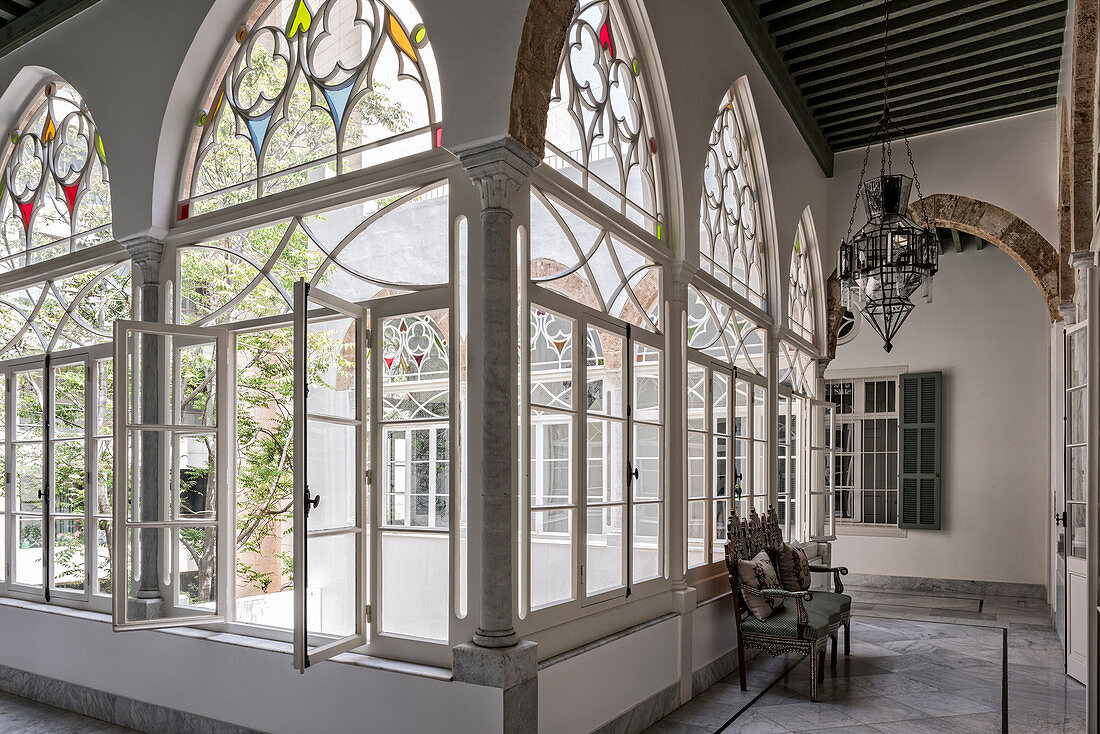 Arched, stained-glass windows overlooking courtyard of Oriental palace