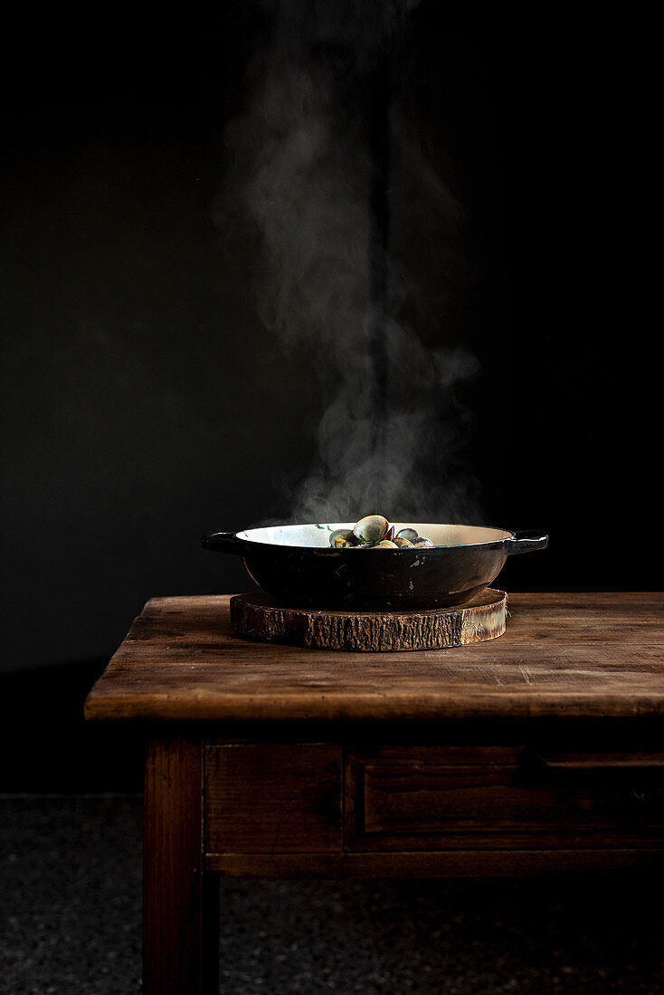 Frying pan with steaming freshly cooked dish