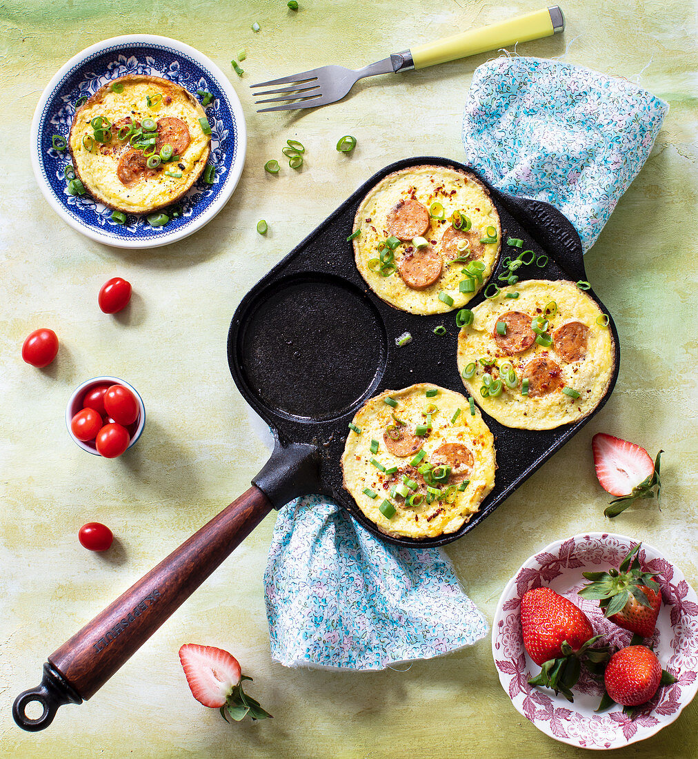 Mini omelettes with sausages in omelet pan