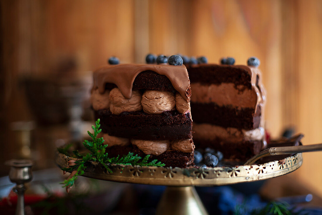 A Christmas chocolate cream cake with ganache and blueberries