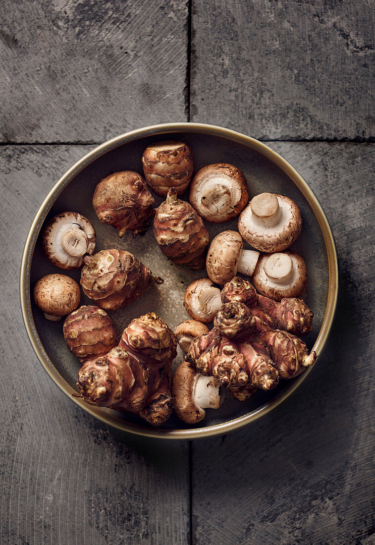 Jerusalem artichokes and mushrooms in a ceramic bowl
