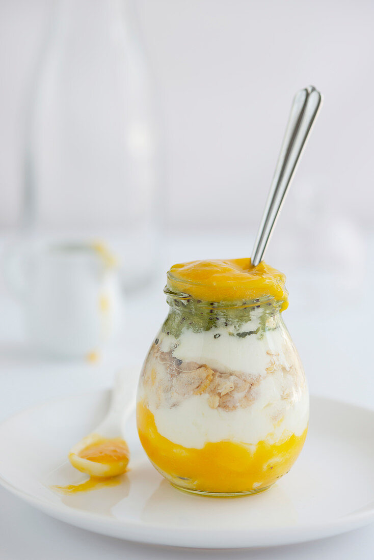 Yoghurt muesli with fruits smoothie in a jar