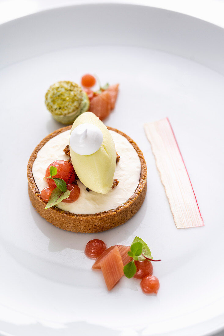 A rhubarb tartlet with woodruff ice cream and a macaroon