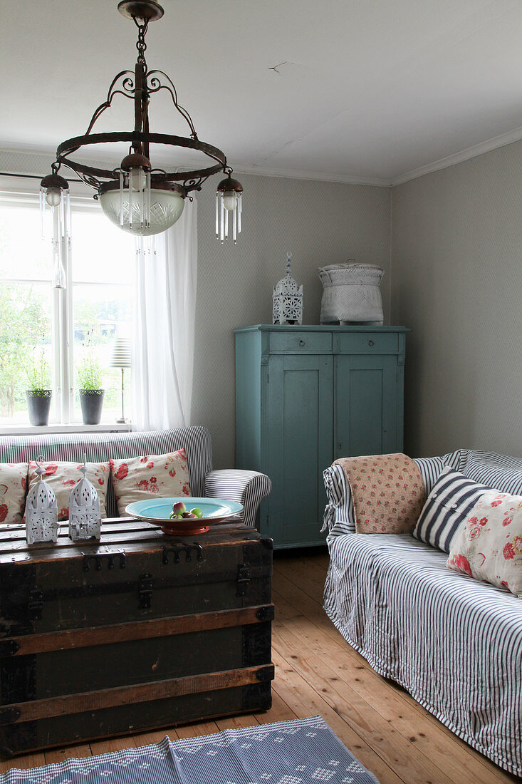 Old steamer trunk used as coffee table in vintage-style living room