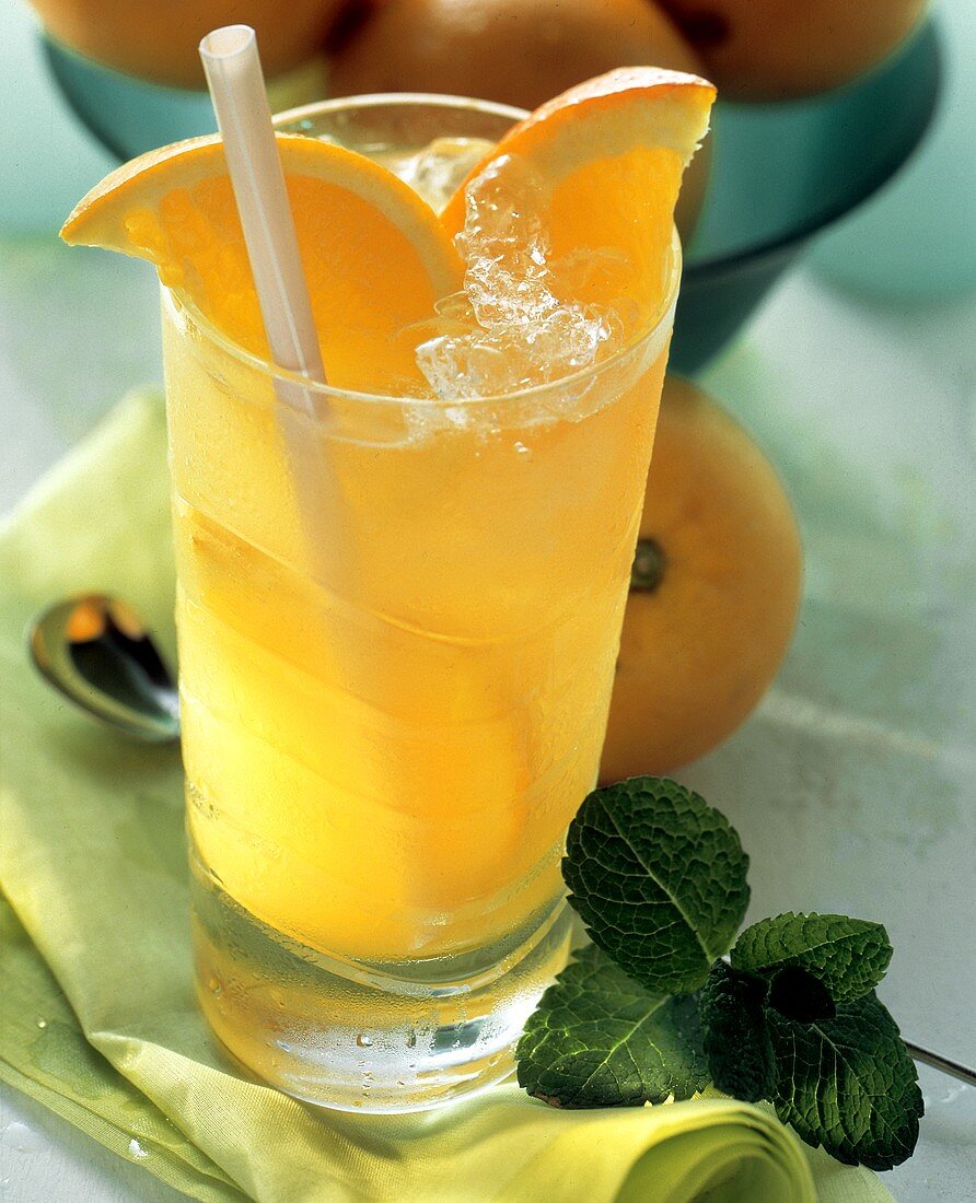 A Cold Glass of Orange Juice with Ice and a Straw