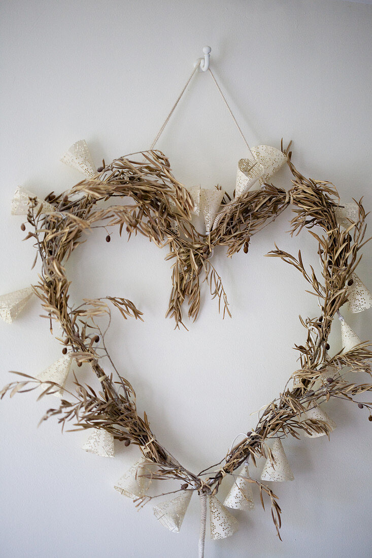Heart wreath made of dried olive branches and fairy lights