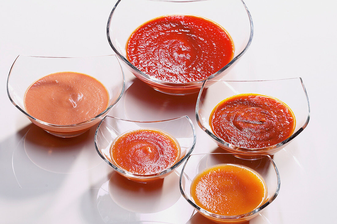 Variations of tomato sauce in glass bowls