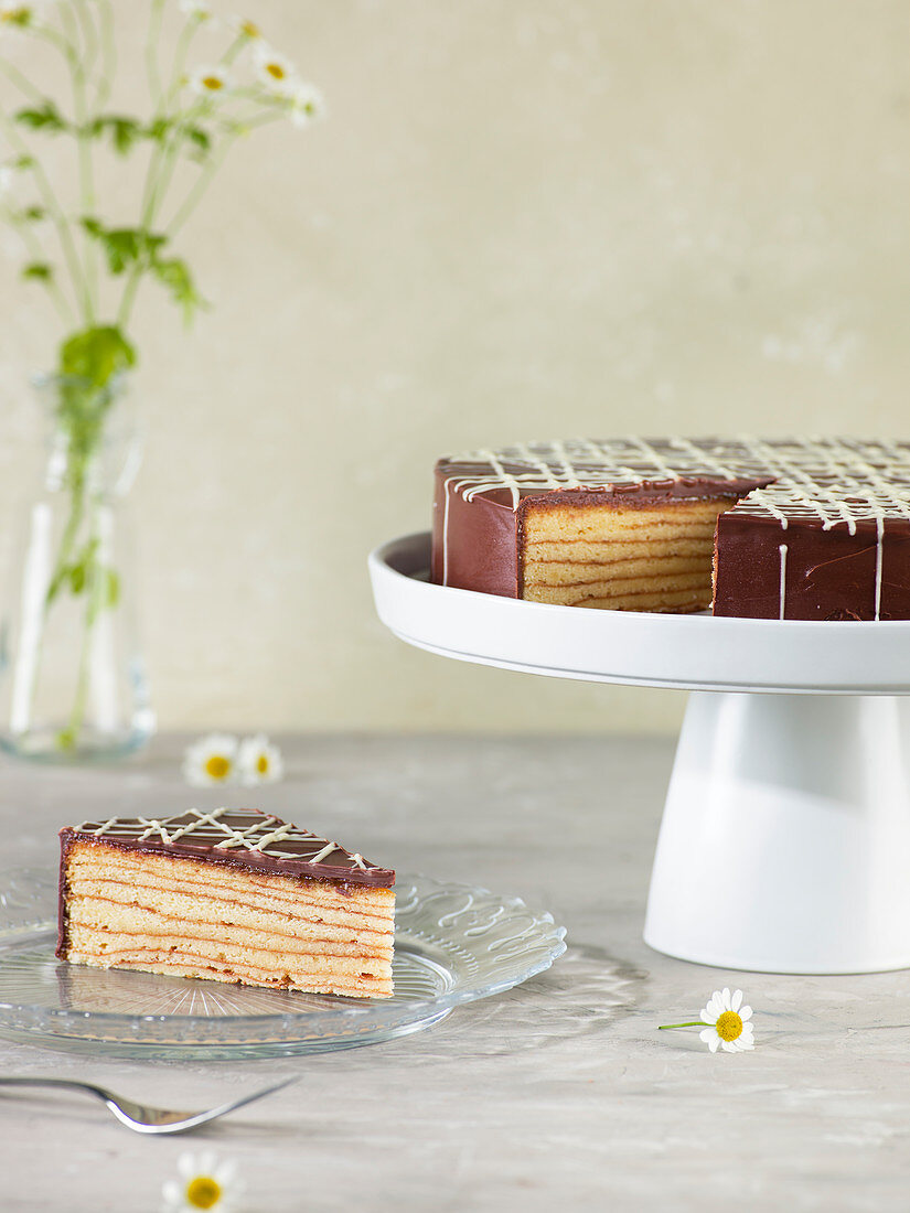 Baumkuchen (German layer cake) with one piece on a plate