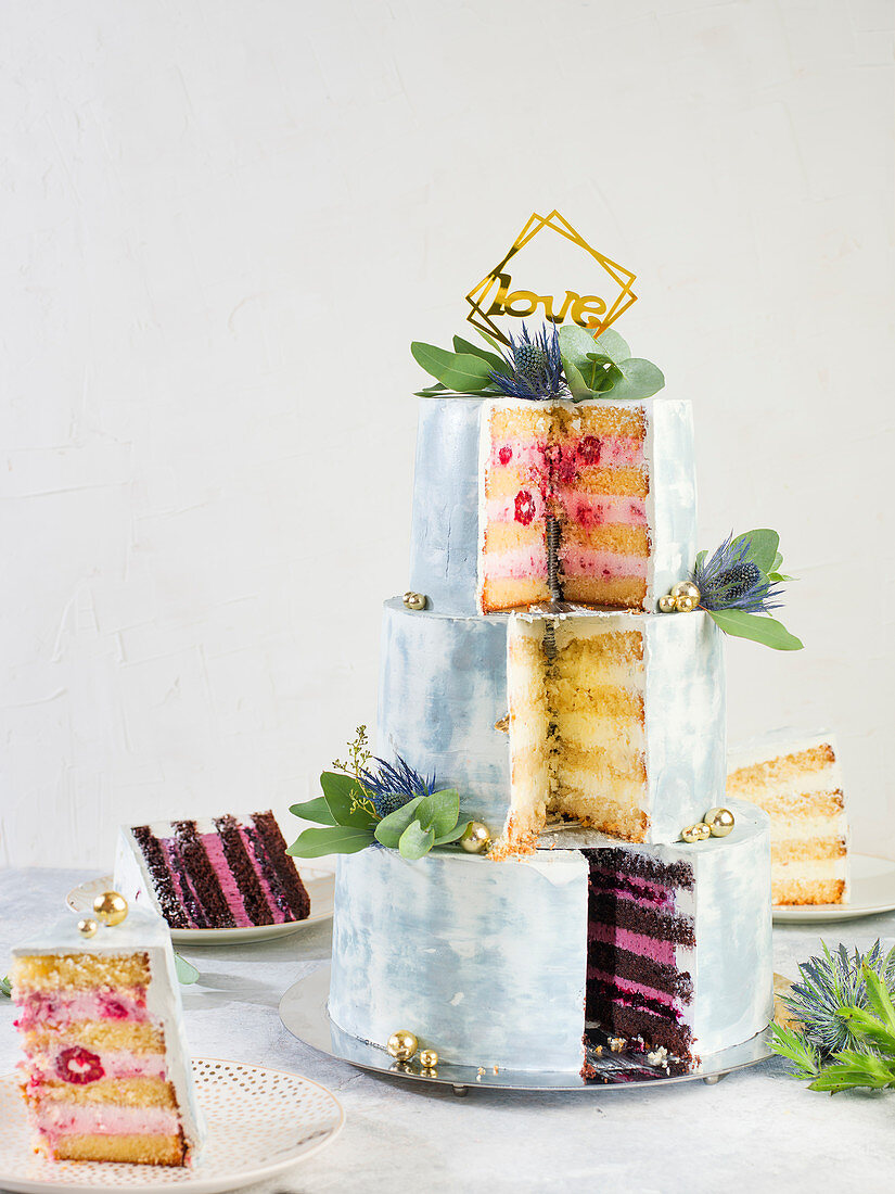 A three-tier wedding cake, sliced