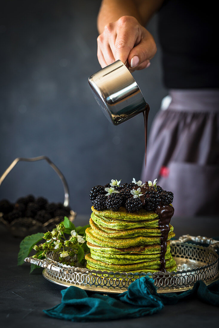 Spinach pancakes with blackberries and chocolate sauce