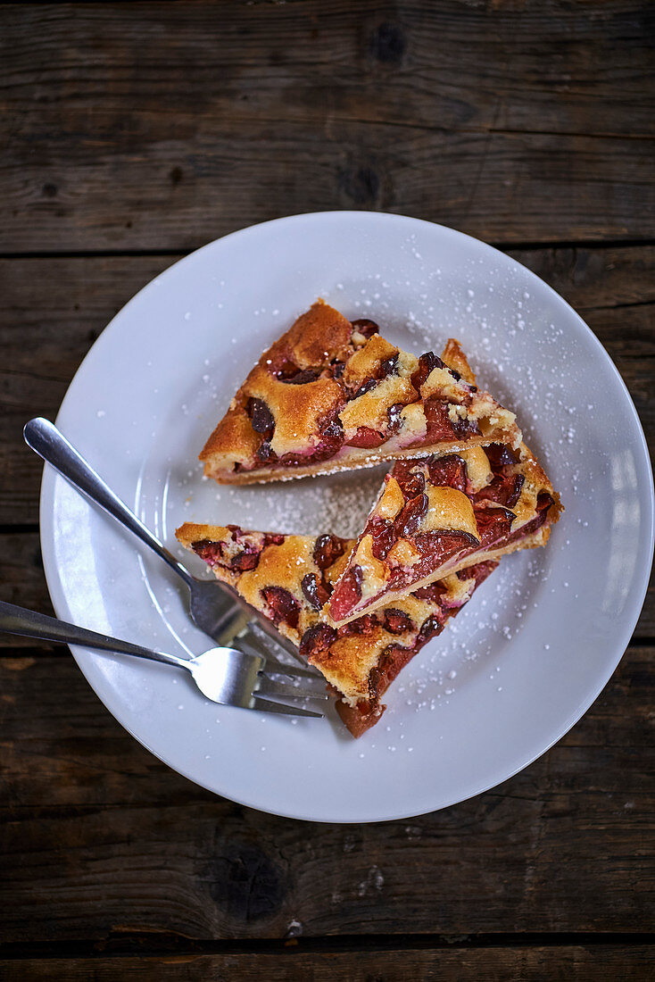 Three slices of damson cake on a plate