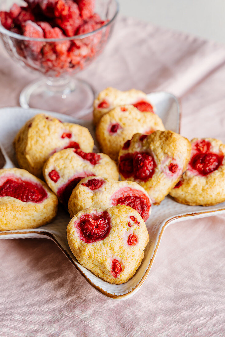 Heart-shaped vanilla shortcake biscuits with raspberries