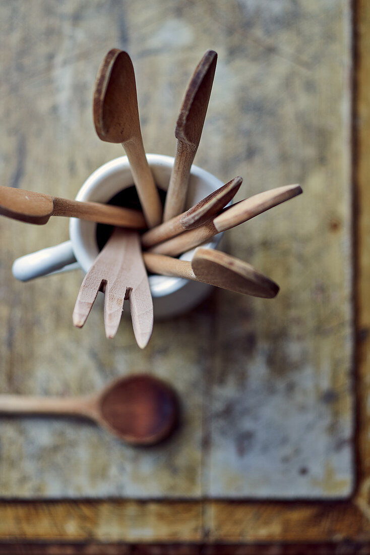 Wooden spoons and utensils in a porcelain jug