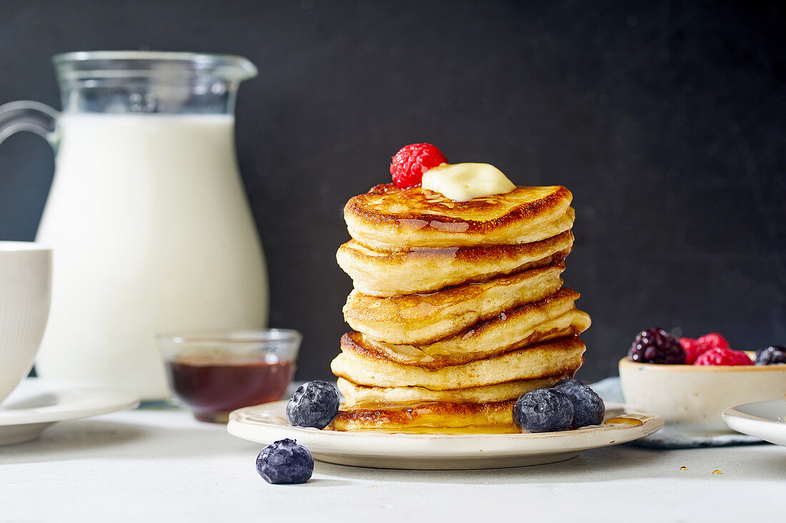 Pancakes with maple syrup, butter and berries