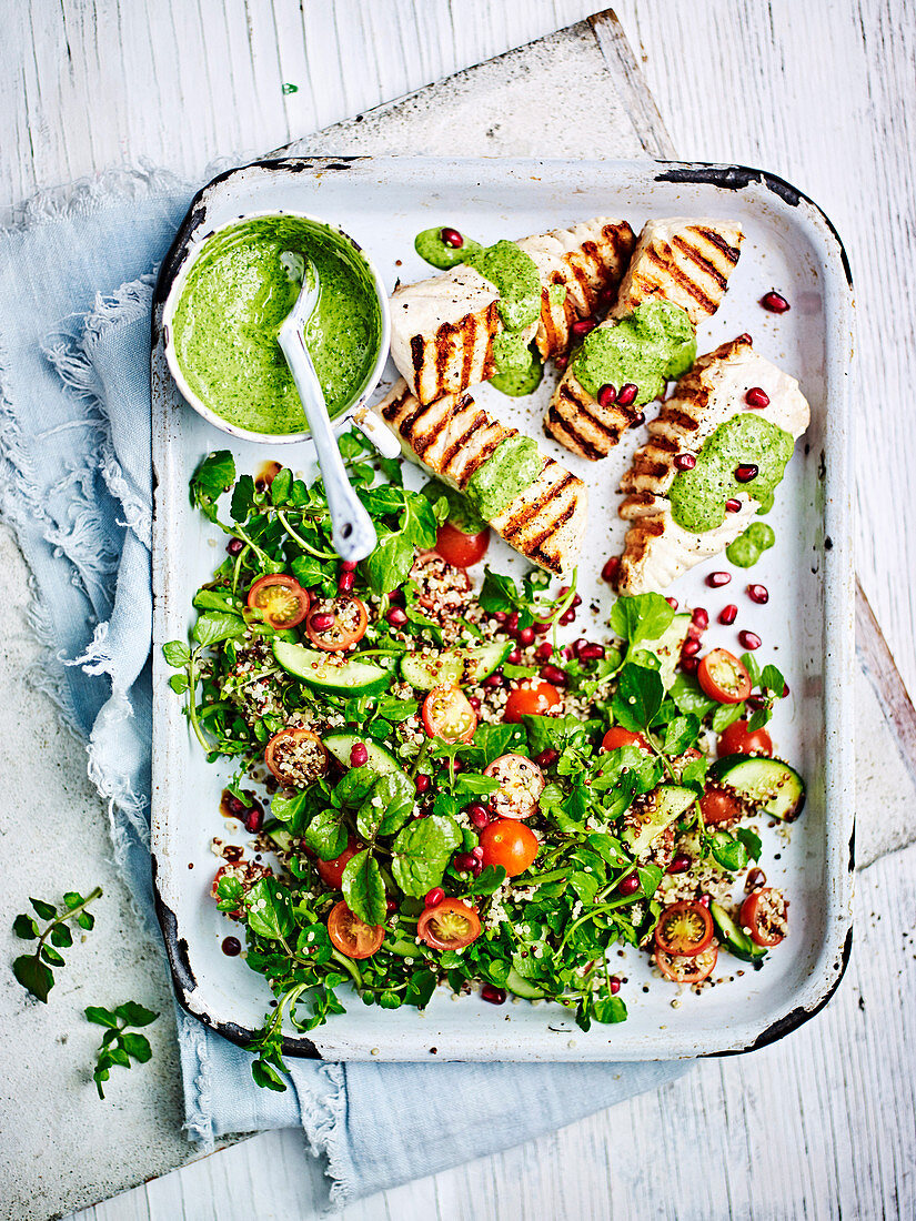 Quinoa salad with grilled fish and green hummus