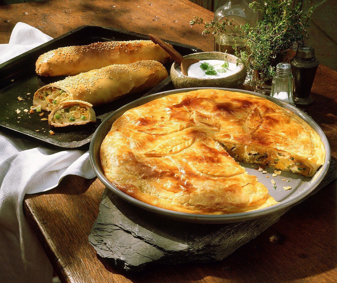 Pumpkin pie; filled pastry rolls with vegetables; sour cream