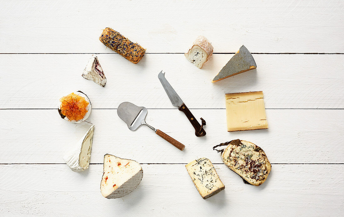 Various cheeses with a slicer and a cheese knife