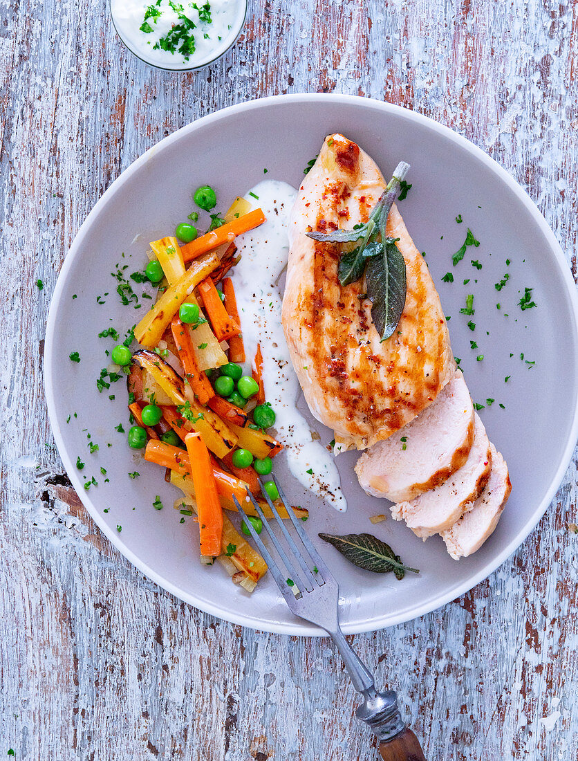 Chicken breast fillet with sage served with spring vegetables and a dip