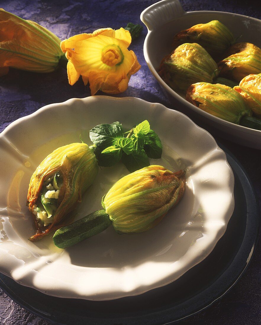 Two courgette flowers with courgette stuffing on plate