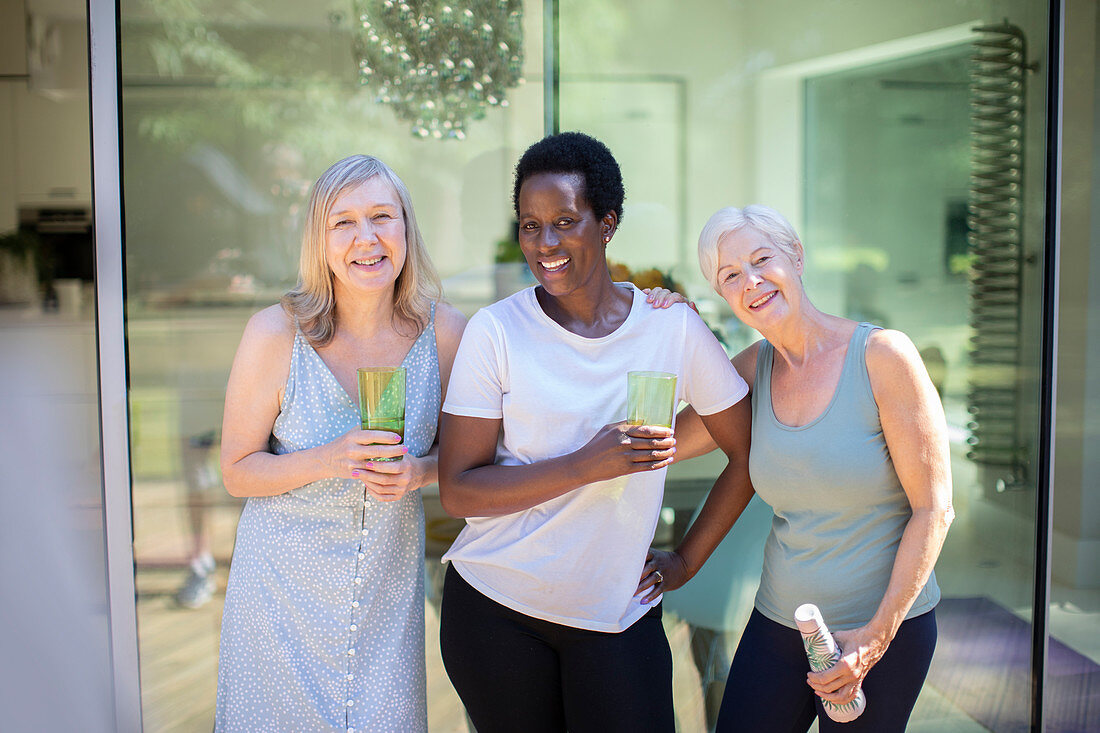 Portrait senior women drinking water on summer patio