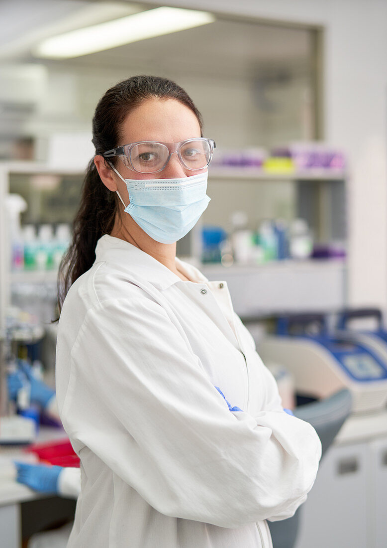 Portrait confident scientist in face mask and goggles