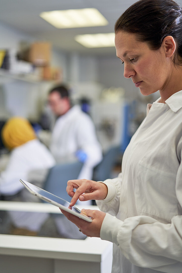 Female scientist using digital tablet in laboratory