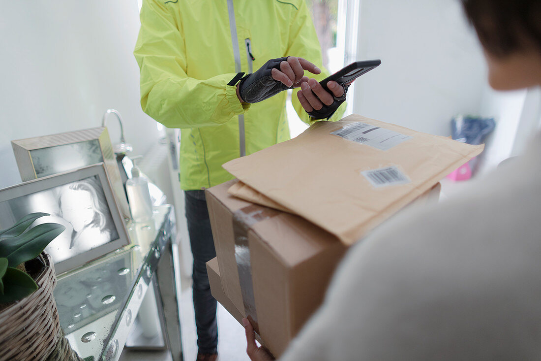 Woman receiving packages from delivery man
