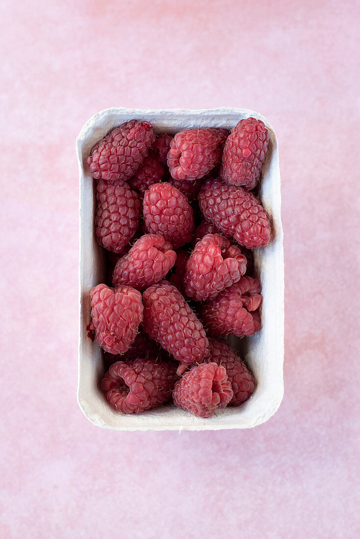 Raspberries in a paper box