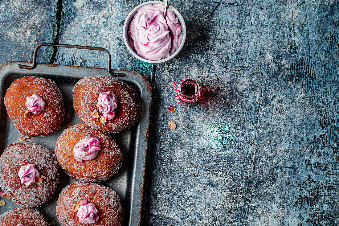 Vegan donuts with rose cream and jam