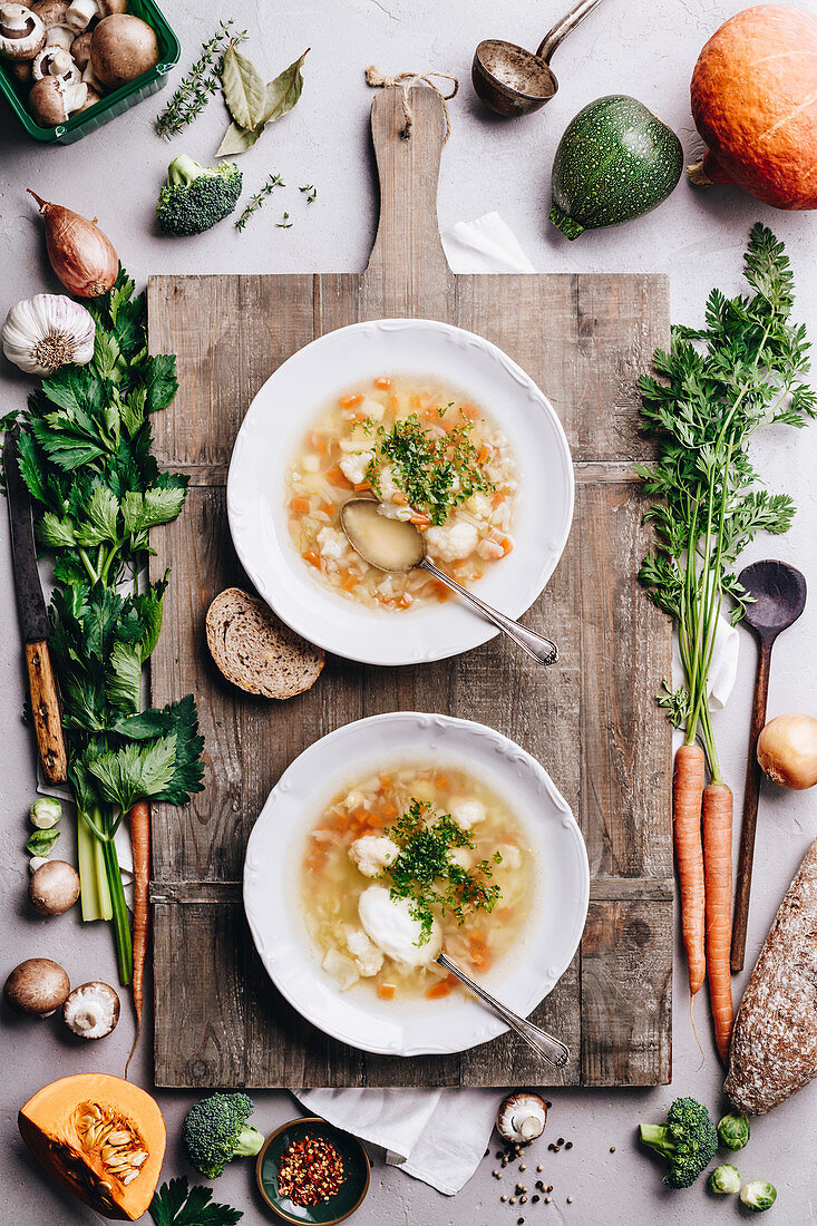 White plates of homemade vegetable soup