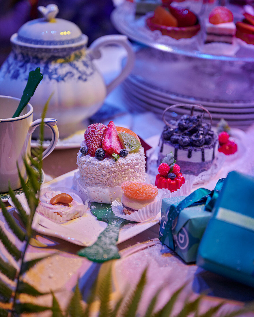 Festively decorated table with cupcakes and gifts