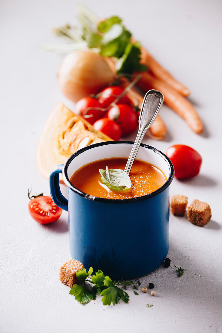 Tomato soup in old metal cup