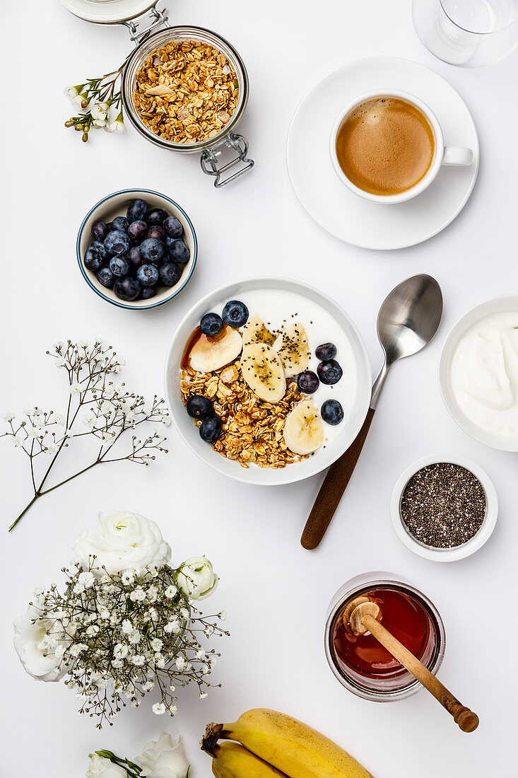 Healthy breakfast with granola, yogurt, coffee, fruits and chia seeds