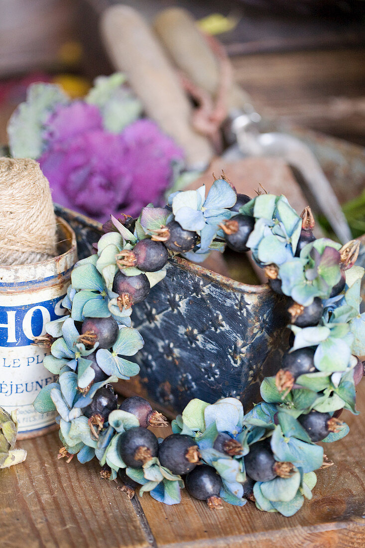 Wreath of blue hydrangea blossoms and berries