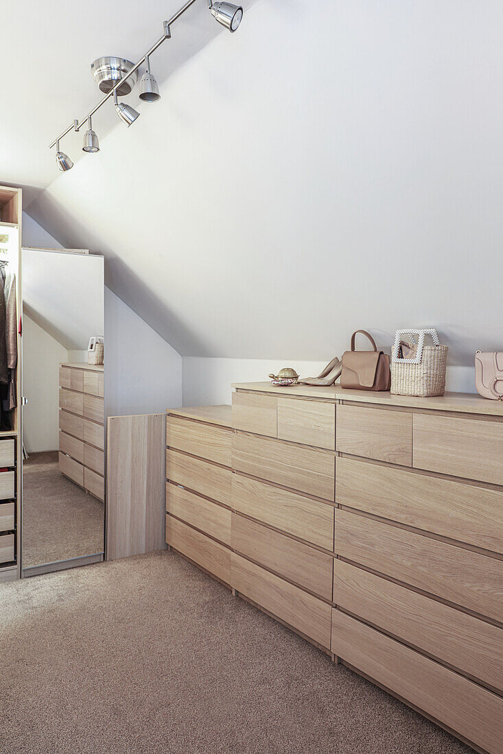 Chests of drawers and full-length mirror in attic dressing room