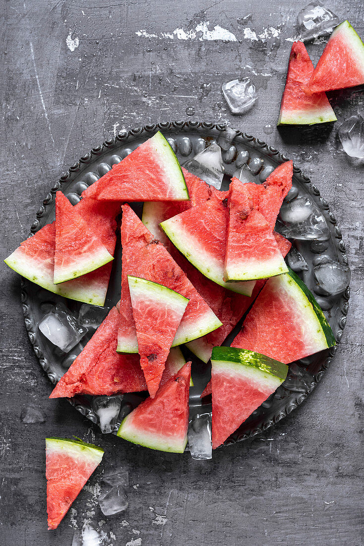 Slices of watermelon on a grey plate