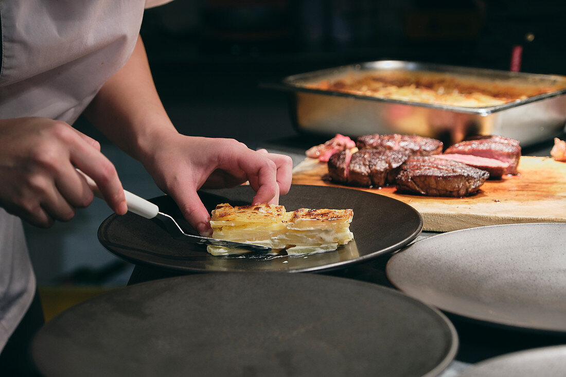 Chefs preparing dishes in French restaurant