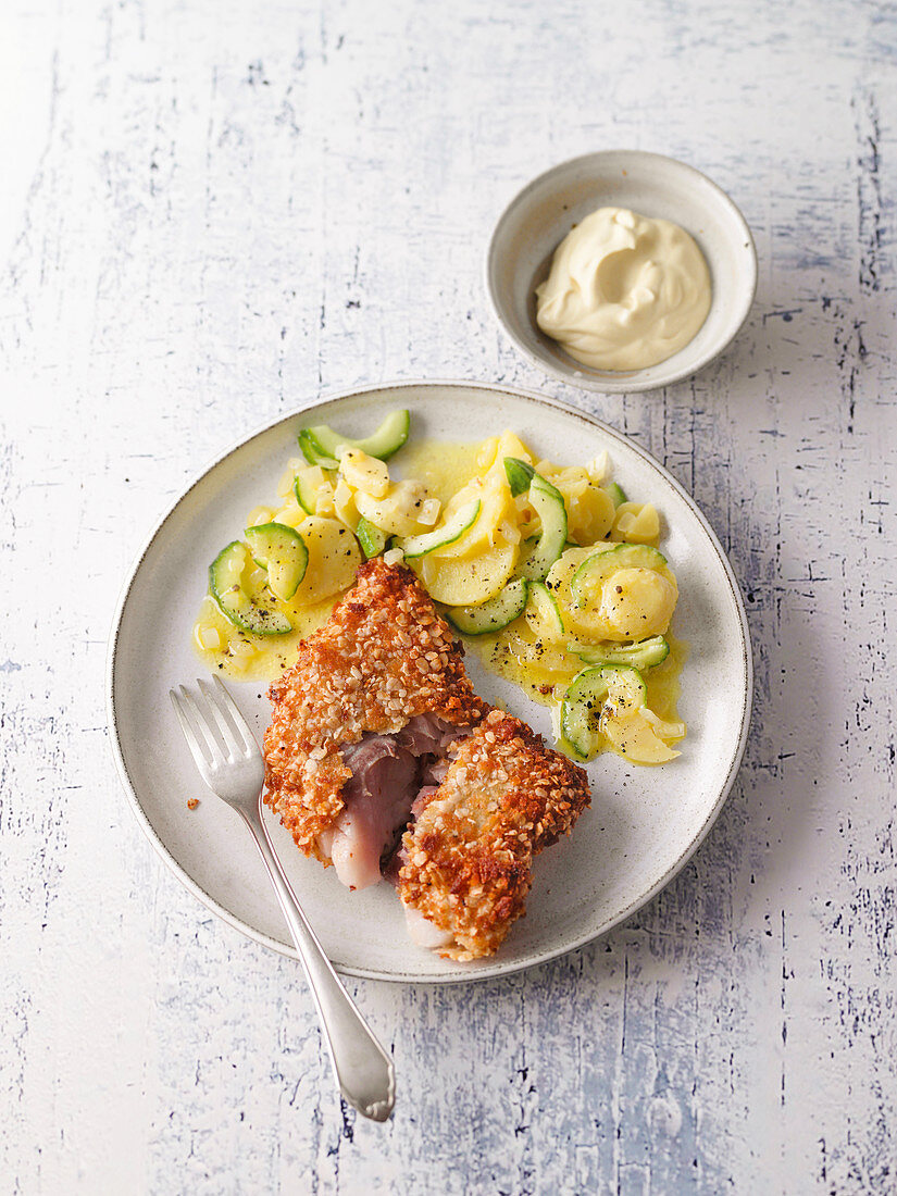 Baked fish with cucumber and potato salad and mustard dip