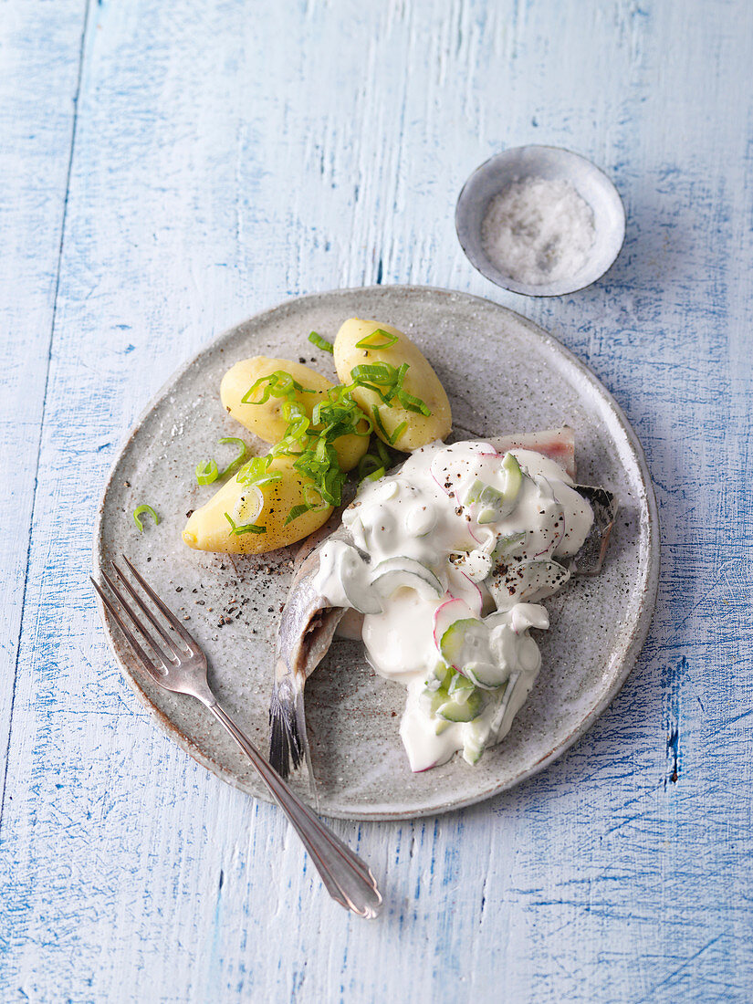 Herring in cucumber-radish sour cream with baked potatoes