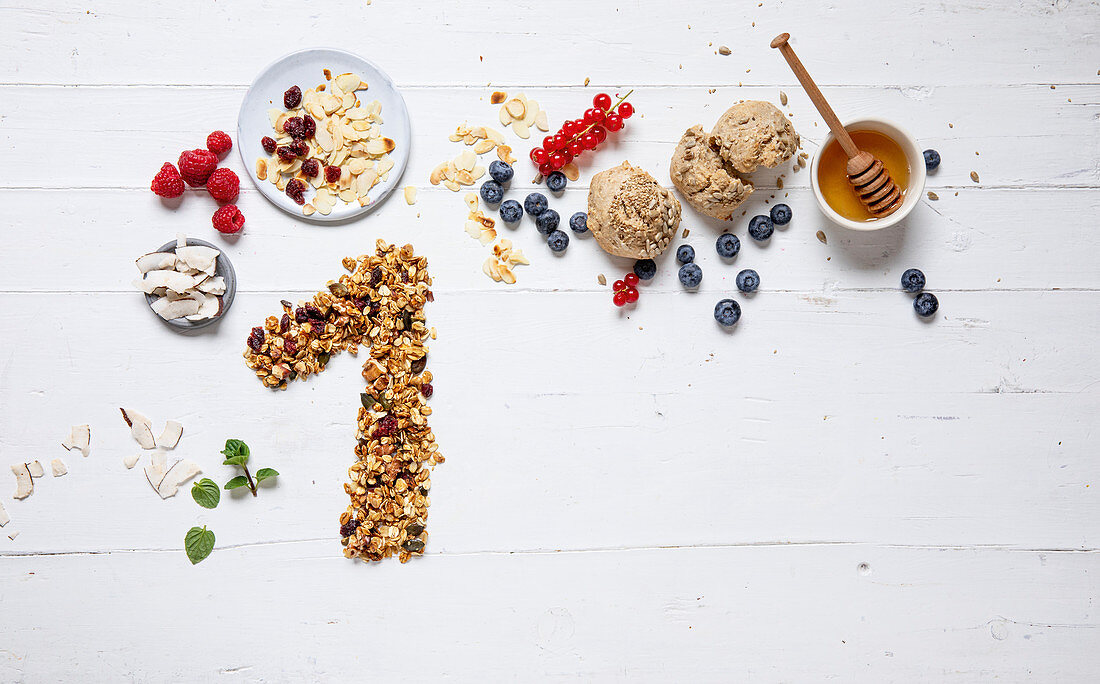 Ingredients for healthy breakfast and muesli laid out to form a ‘1’