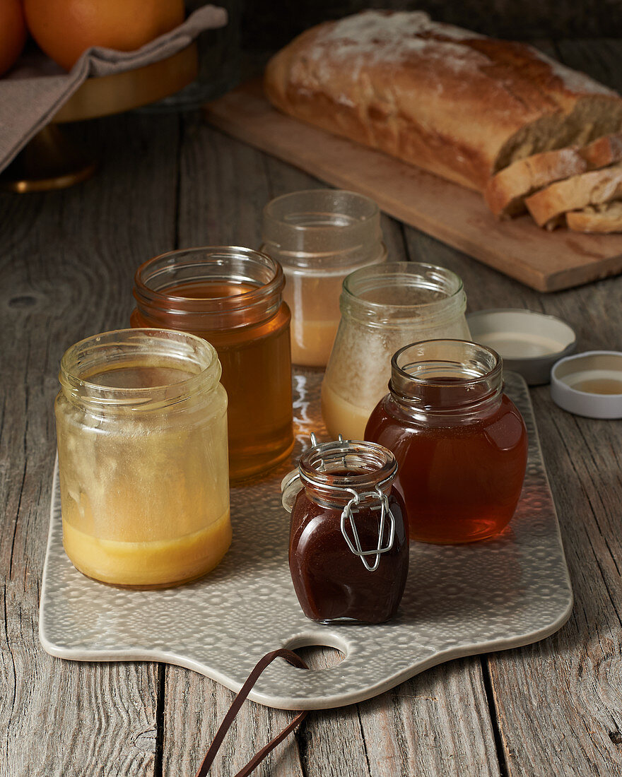 Different kinds of honey in jars on a breakfast table