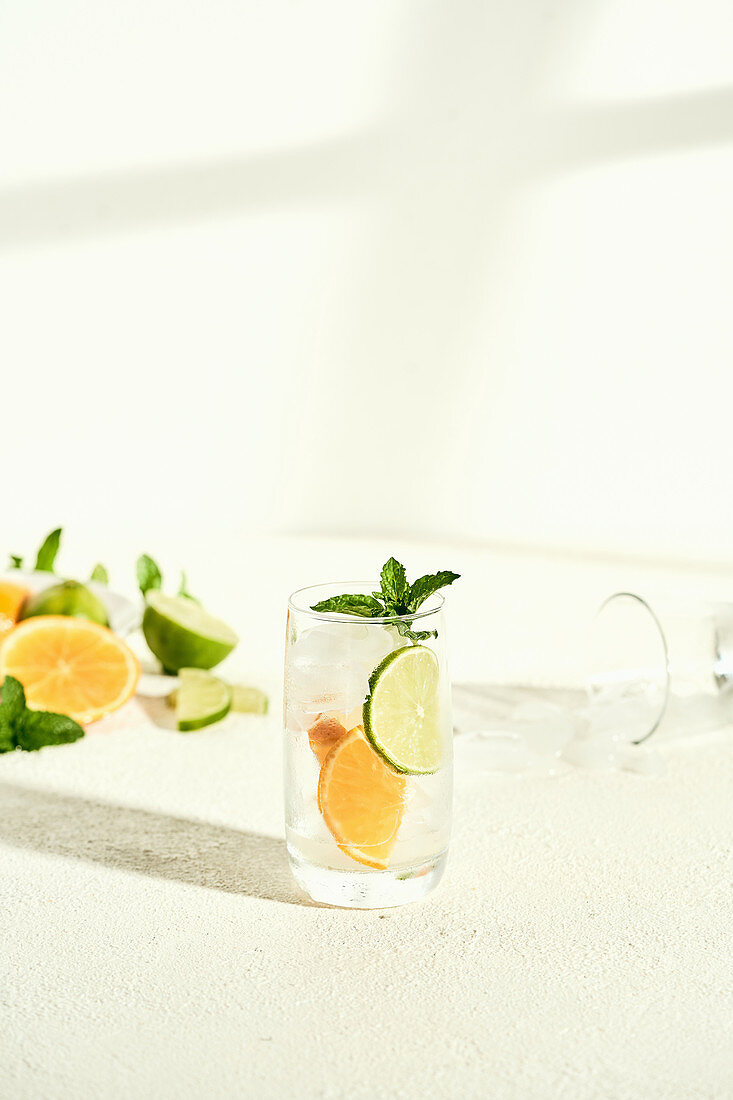 Glass of water with lime, orange and mint