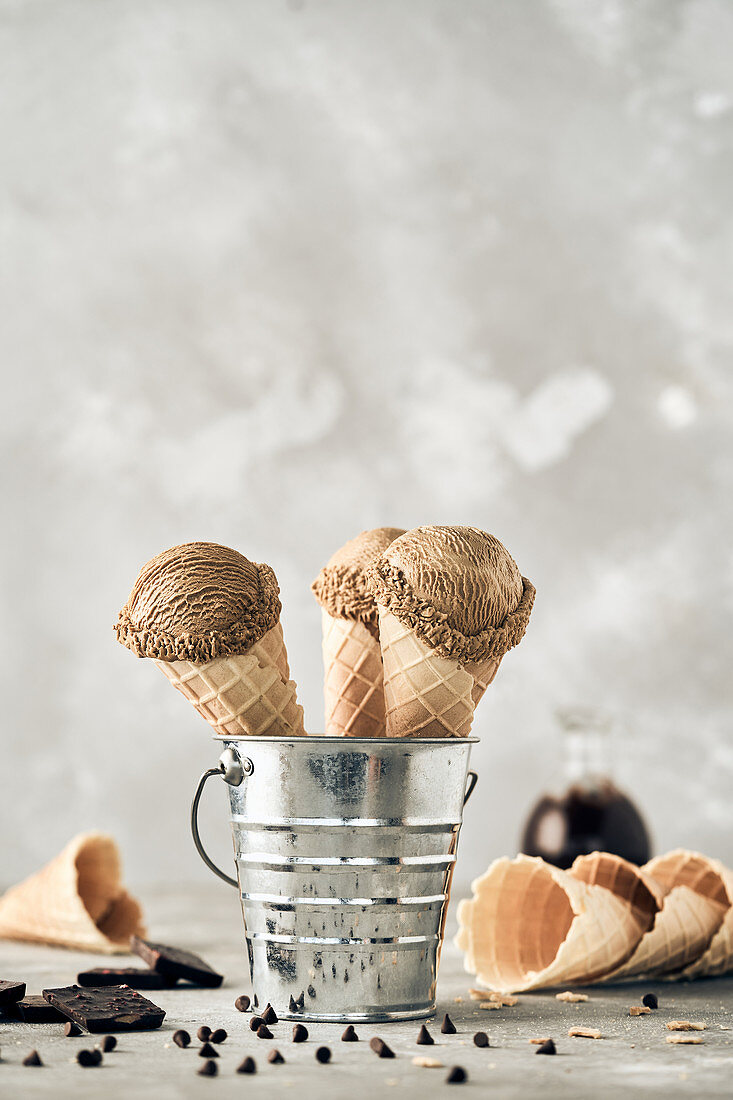 Scoops of chocolate ice cream in waffle cones