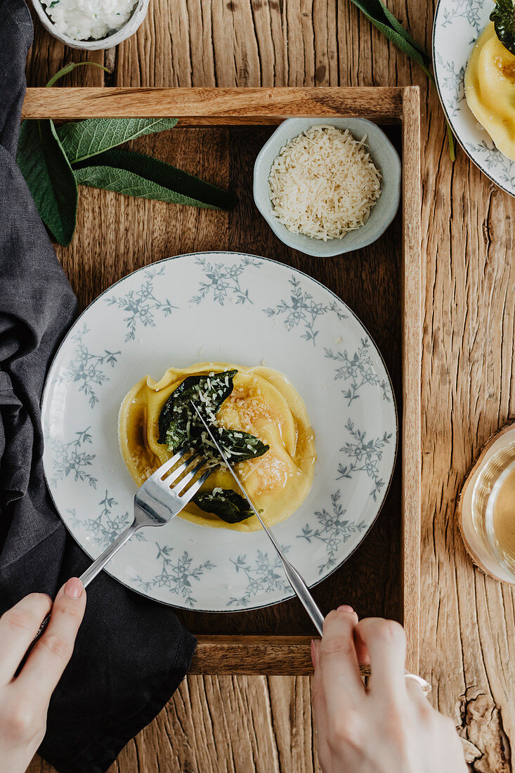 Eating ravioli with sage butter