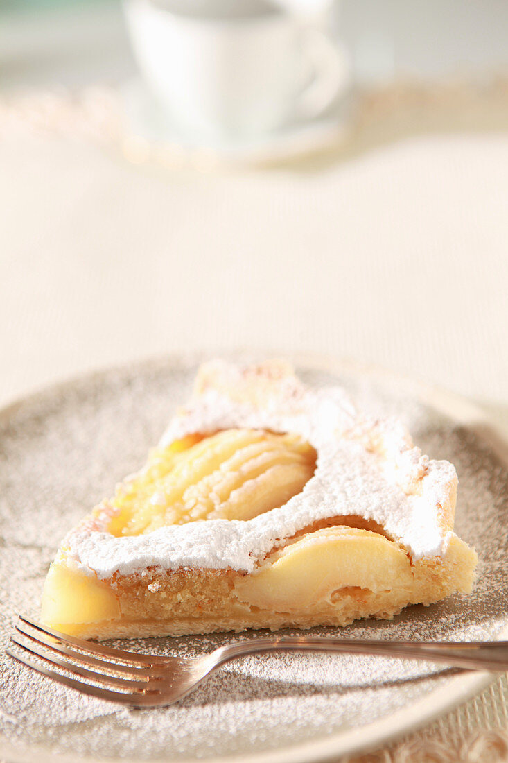 A piece of pear crostata with almonds